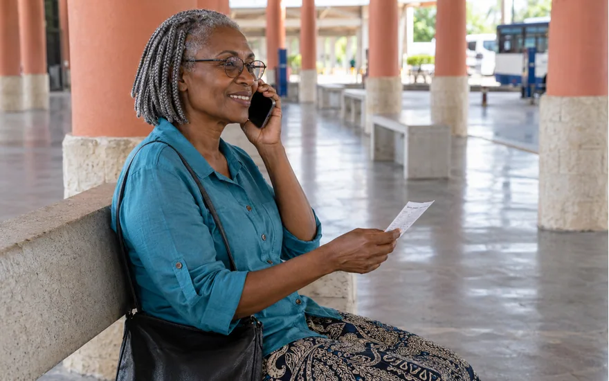 Wasafi Bet support preparation illustrated by an adult making a phone call while holding a private sports receipt