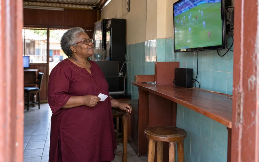 WasafiLigi virtual-football information illustrated by an adult watching a defocused simulated football screen